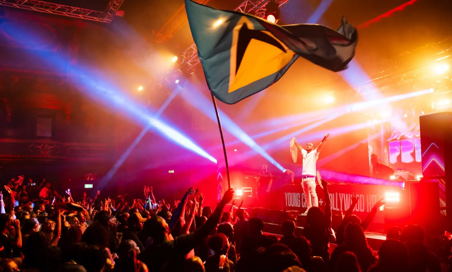 A packed Busspepper night in London, flag waving under the stage lights